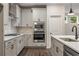 Modern kitchen features stainless steel appliances, sleek white countertops, and gas range at 3564 Arrow Root Cir, Loganville, GA 30052