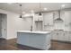 Well-lit kitchen showcases a large island, modern appliances, and ample counter space at 3564 Arrow Root Cir, Loganville, GA 30052