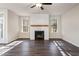 Sun-filled living room featuring a modern fireplace, natural light, and attractive flooring at 3564 Arrow Root Cir, Loganville, GA 30052