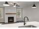 Open concept living area with a modern fireplace and expansive windows overlooking nature at 3564 Arrow Root Cir, Loganville, GA 30052