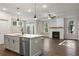 Bright, open-concept space featuring kitchen with an island and a cozy living room with fireplace at 3564 Arrow Root Cir, Loganville, GA 30052