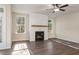 Cozy living room showcasing a fireplace with custom mantle and many windows overlooking the trees at 3564 Arrow Root Cir, Loganville, GA 30052