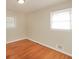Bedroom with hardwood floors, neutral walls, and two windows for natural light at 6575 Wendell Cir, Morrow, GA 30260