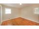 Cozy bedroom with hardwood floors, neutral walls, and two windows for natural light at 6575 Wendell Cir, Morrow, GA 30260