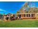 Charming brick home with a well-manicured lawn and classic curb appeal on a sunny day at 6575 Wendell Cir, Morrow, GA 30260