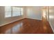 Bright living room featuring gleaming hardwood floors and natural light from large windows at 6575 Wendell Cir, Morrow, GA 30260