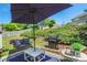 Outdoor patio area with seating, a grill, lush lawn and landscape at 868 Cork Oak Ln, Lawrenceville, GA 30045
