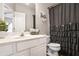 Updated bathroom with white cabinets, a toilet, and a shower with a curtain at 868 Cork Oak Ln, Lawrenceville, GA 30045