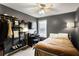 Bedroom with a built-in desk, TV, shelving and a large window at 868 Cork Oak Ln, Lawrenceville, GA 30045