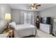 Cozy bedroom with a ceiling fan, dresser, and a comfortable bed at 868 Cork Oak Ln, Lawrenceville, GA 30045