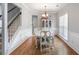 Bright dining room featuring hardwood floors, a chandelier, and natural light at 868 Cork Oak Ln, Lawrenceville, GA 30045