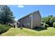 Spacious backyard with patio furniture, lush green lawn, and mature trees at 868 Cork Oak Ln, Lawrenceville, GA 30045