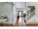 Inviting foyer with hardwood floors, staircase, and view into living area with fireplace at 868 Cork Oak Ln, Lawrenceville, GA 30045