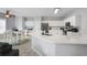 Modern kitchen with white cabinets, stainless steel appliances, and granite countertops, open to dining area at 868 Cork Oak Ln, Lawrenceville, GA 30045