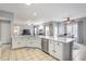 Bright open kitchen featuring a large island, stainless steel appliances, and views into the living spaces at 868 Cork Oak Ln, Lawrenceville, GA 30045