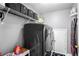 A functional laundry room with new washer and dryer, storage shelves, and neutral paint at 868 Cork Oak Ln, Lawrenceville, GA 30045