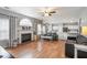 Spacious living room with fireplace, hardwood floors, ceiling fan, and open layout to kitchen at 868 Cork Oak Ln, Lawrenceville, GA 30045