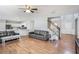 Open-concept living space with hardwood floors, staircase, and view into the modern kitchen at 868 Cork Oak Ln, Lawrenceville, GA 30045