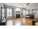 Bright living room featuring fireplace, large window, hardwood floors, and comfortable seating area at 868 Cork Oak Ln, Lawrenceville, GA 30045
