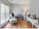 Cozy sitting room with beautiful hardwood floors and a large window at 868 Cork Oak Ln, Lawrenceville, GA 30045