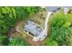 Stunning aerial shot of a well-manicured home with an expansive roof, surrounded by lush greenery and a curved driveway at 4002 Turnstone Nw Dr, Kennesaw, GA 30152