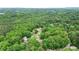 Wide aerial shot showcasing a quiet neighborhood with abundant greenery, and a home with a well-manicured yard at 4002 Turnstone Nw Dr, Kennesaw, GA 30152