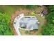Aerial view of a well-maintained property featuring a spacious roof, lovely landscaping, and a private driveway at 4002 Turnstone Nw Dr, Kennesaw, GA 30152