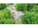 A peaceful neighborhood showcasing a beautiful home surrounded by lush trees and well-maintained landscaping at 4002 Turnstone Nw Dr, Kennesaw, GA 30152