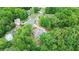 Expansive aerial view of a lush neighborhood, featuring a home with a sprawling yard and mature trees at 4002 Turnstone Nw Dr, Kennesaw, GA 30152