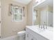 Bright bathroom featuring a white vanity and toilet, complemented by white wall and marble tile flooring at 4002 Turnstone Nw Dr, Kennesaw, GA 30152