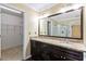 Bathroom with double vanity, granite countertop, and view into the glass shower and walk-in closet at 4002 Turnstone Nw Dr, Kennesaw, GA 30152