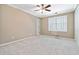 Spacious bedroom with neutral carpet, ceiling fan, and plantation shutters providing natural light at 4002 Turnstone Nw Dr, Kennesaw, GA 30152