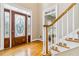Inviting foyer features gleaming hardwood floors, elegant staircase, and a sophisticated stained glass front door at 4002 Turnstone Nw Dr, Kennesaw, GA 30152