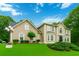 Charming two-story home featuring a well-manicured lawn, beautiful landscaping, and a classic architectural style at 4002 Turnstone Nw Dr, Kennesaw, GA 30152