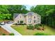 Elegant two-story home boasts a manicured lawn, lush landscaping, and a welcoming entrance, creating great curb appeal at 4002 Turnstone Nw Dr, Kennesaw, GA 30152