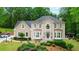 Charming two-story home featuring a well-maintained lawn, decorative shrubs, and classic architectural details at 4002 Turnstone Nw Dr, Kennesaw, GA 30152