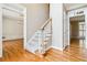 Open foyer showcasing a staircase, hardwood floors, and views into the dining room and living spaces at 4002 Turnstone Nw Dr, Kennesaw, GA 30152