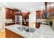 An open kitchen with hardwood floors and granite countertops at 4002 Turnstone Nw Dr, Kennesaw, GA 30152
