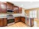 A kitchen with hardwood floors and stainless steel appliances at 4002 Turnstone Nw Dr, Kennesaw, GA 30152