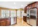 A kitchen with hardwood floors and stainless steel appliances at 4002 Turnstone Nw Dr, Kennesaw, GA 30152