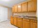 Basement kitchenette features wood cabinets, double sink, and neutral countertops at 4002 Turnstone Nw Dr, Kennesaw, GA 30152