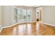 Bright living room with hardwood floors and an abundance of natural light streaming through shuttered windows at 4002 Turnstone Nw Dr, Kennesaw, GA 30152