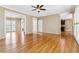 Spacious living area with hardwood floors, neutral walls, ceiling fan, and multiple doorways to adjacent rooms at 4002 Turnstone Nw Dr, Kennesaw, GA 30152