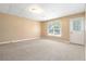 Spacious living room with neutral walls, carpet and bright window for natural light at 4002 Turnstone Nw Dr, Kennesaw, GA 30152
