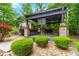 Outdoor brick pergola with black frame, ceiling fan, and stone flooring at 4002 Turnstone Nw Dr, Kennesaw, GA 30152