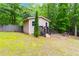 Backyard shed with brown trim, porch, and walking path at 4002 Turnstone Nw Dr, Kennesaw, GA 30152
