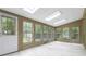 Bright sunroom with tile floor, skylights and many windows overlooking trees at 4002 Turnstone Nw Dr, Kennesaw, GA 30152