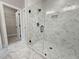 Bathroom featuring a glass shower with marble accents and wire shelving nearby at 5706 Urban Village Way # 4, Tucker, GA 30084
