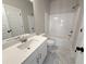 Clean bathroom features white cabinets, marble floors, and a shower and tub combo at 5706 Urban Village Way # 4, Tucker, GA 30084