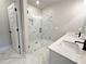 Modern bathroom features a glass shower, double sink, and marble accents at 5706 Urban Village Way # 4, Tucker, GA 30084